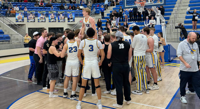 Students and teammate carry Sheridan guard Noah Romine after his 32-point performance in a win over White Hall on Friday night. (Photo submitted)